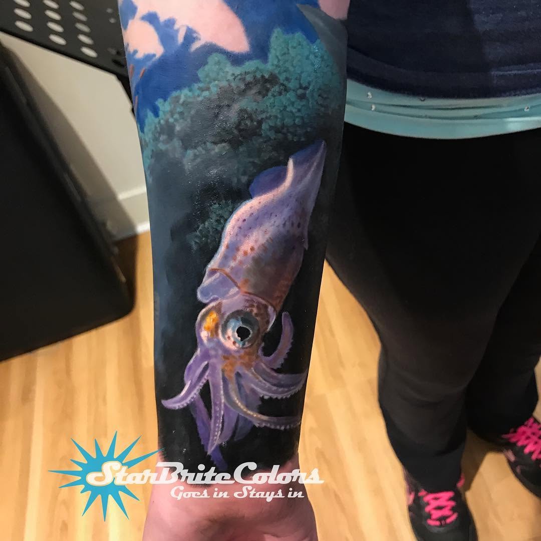 Realistic purple squid underwater sleeve tattoo