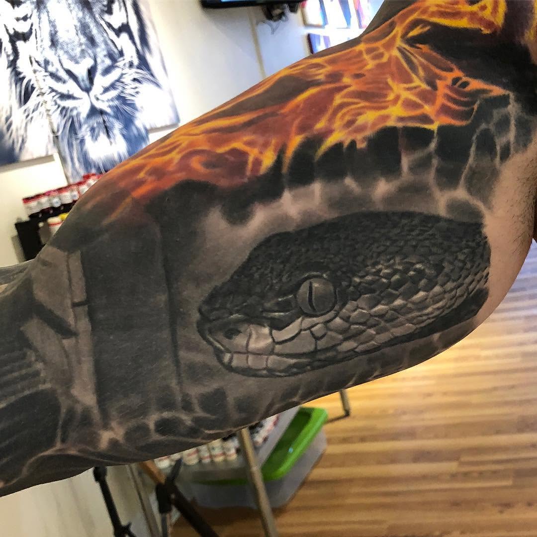 Realistic snake head with flames, arm sleeve