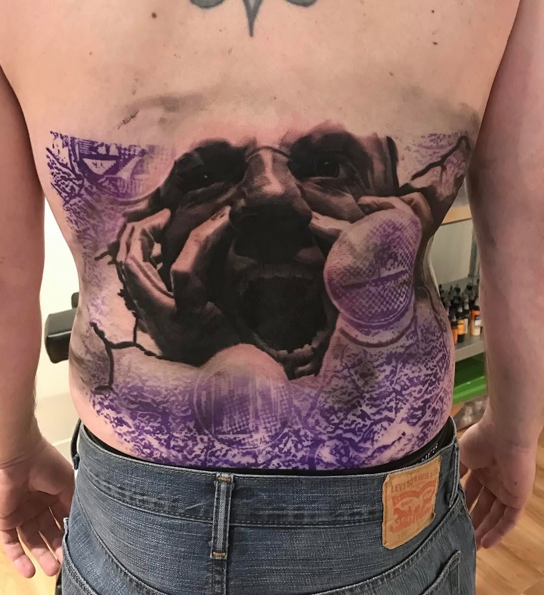 Black-and-grey screaming face tattoo, stomach