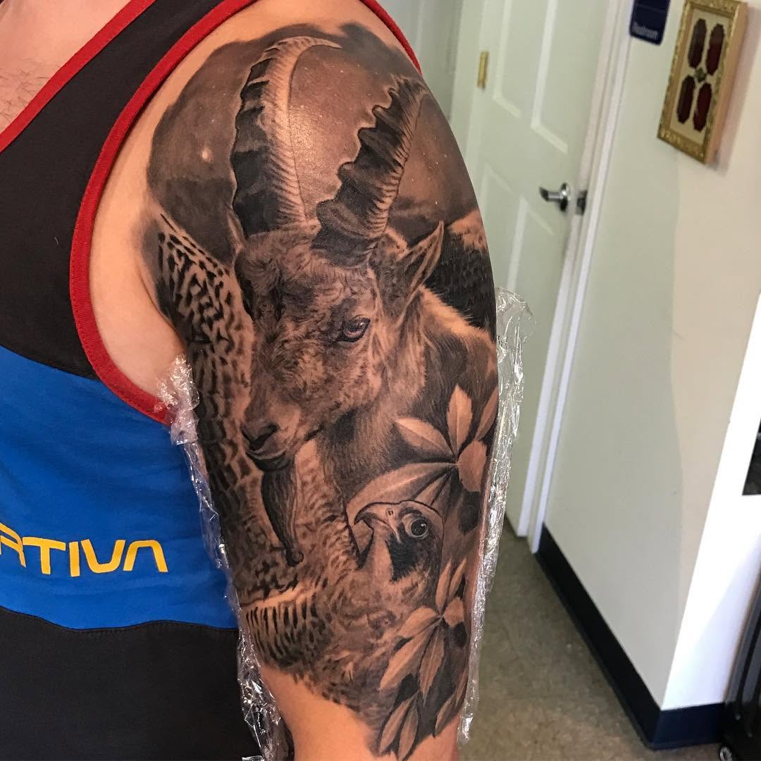 Black-and-grey ibex and falcon half-sleeve