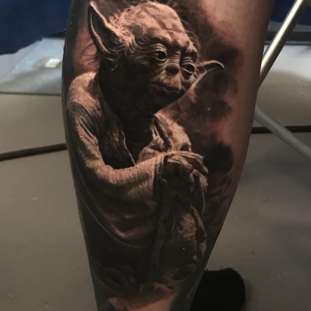Black-and-grey Yoda portrait tattoo on calf