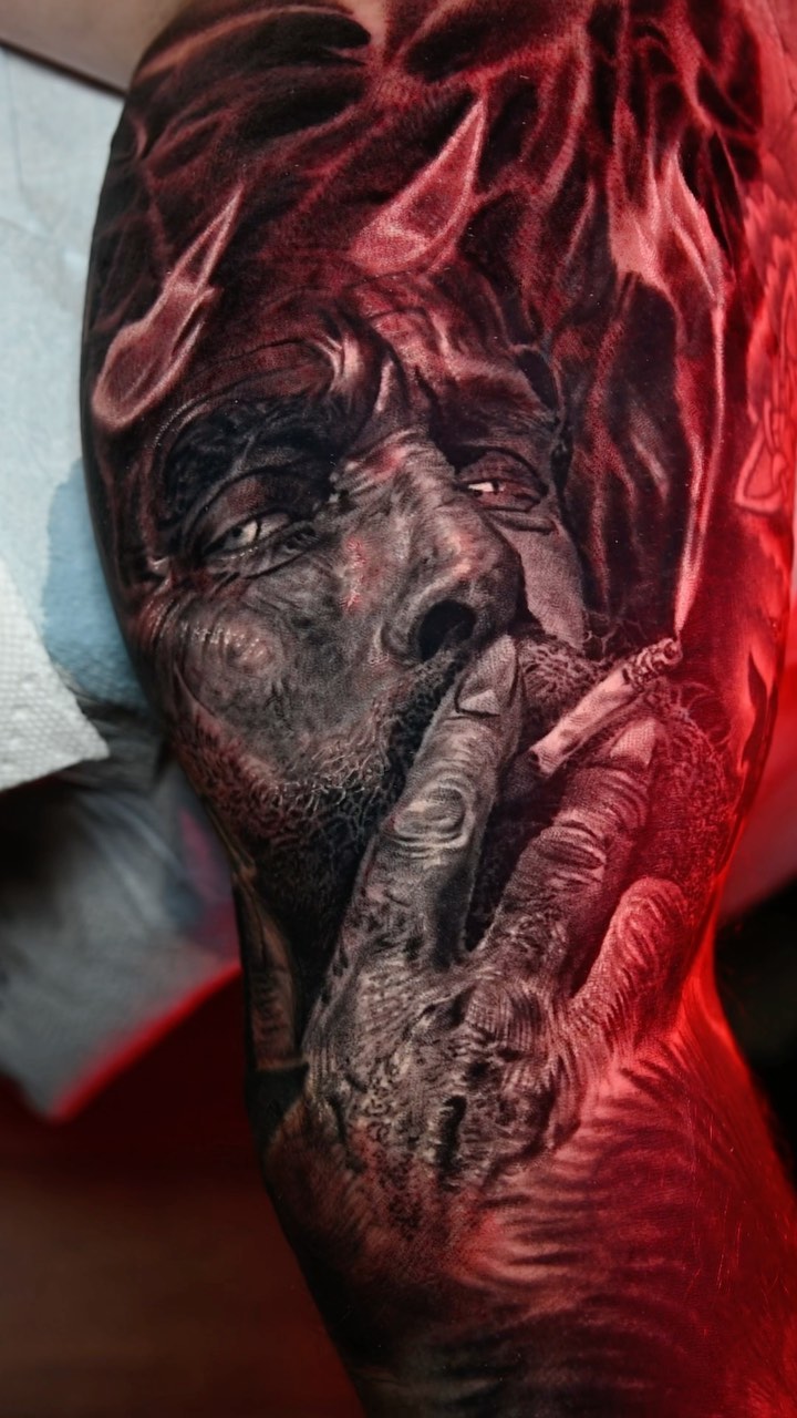 Black-and-grey demon portrait sleeve tattoo