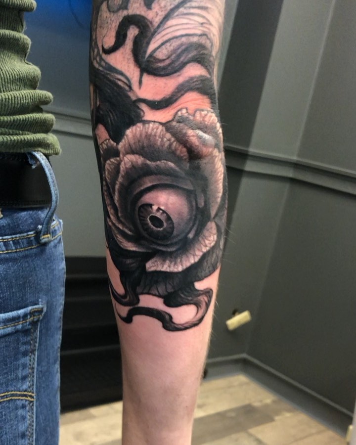 Black-and-grey rose with eyeball, forearm