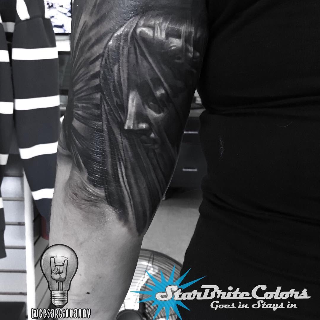 Black-and-grey Virgin Mary portrait, bicep