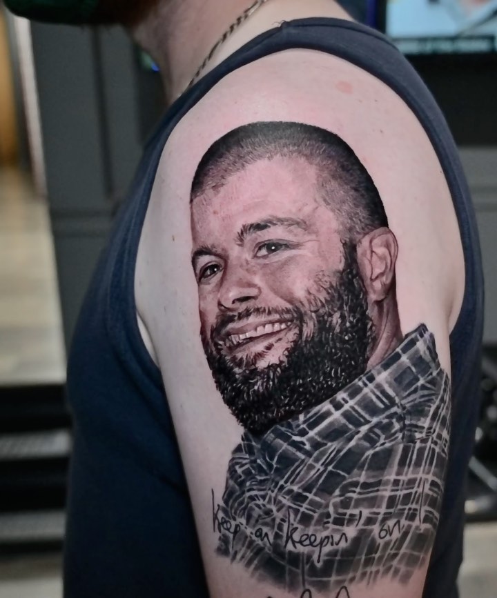 Black-and-grey memorial portrait, bicep