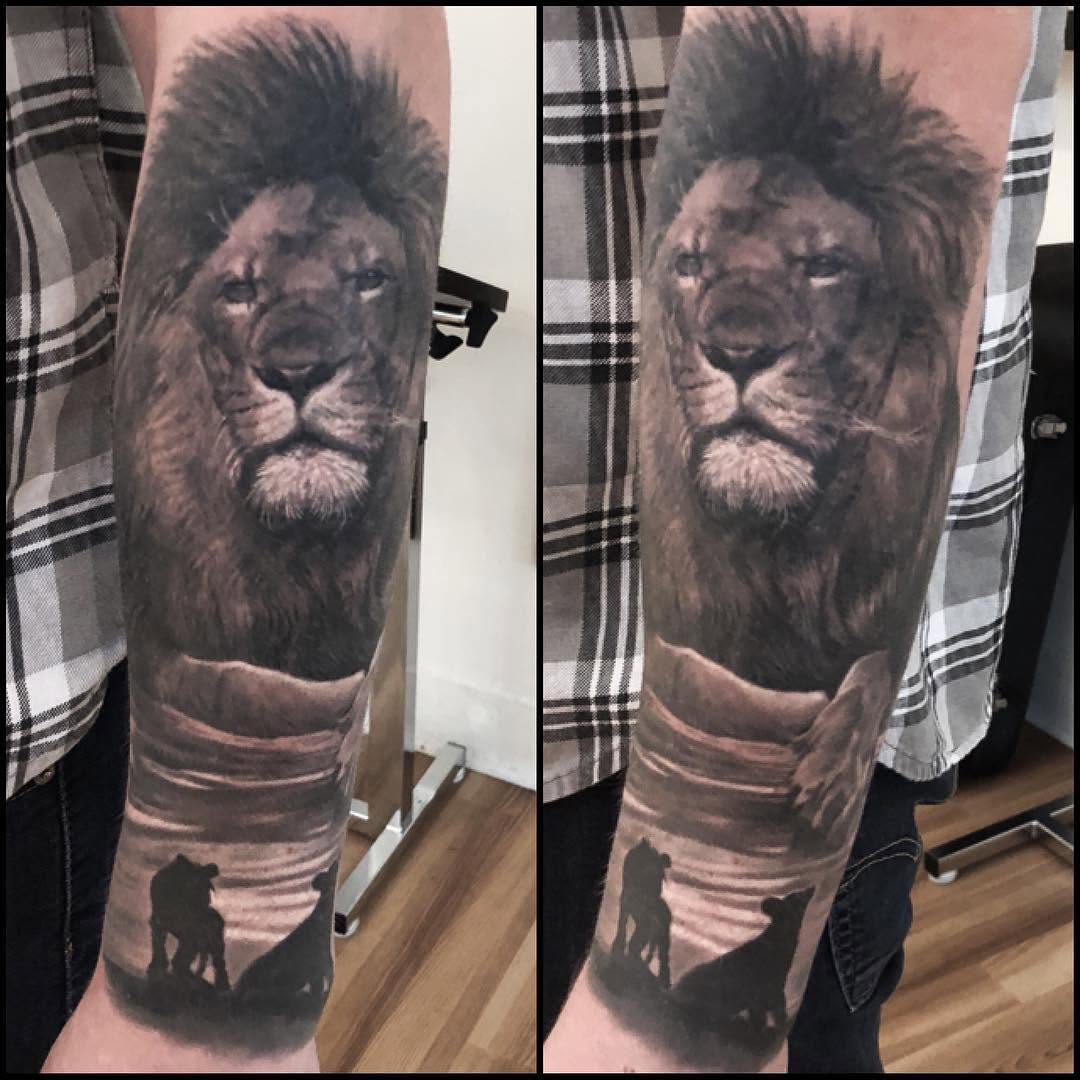 Black-and-grey lion portrait, forearm