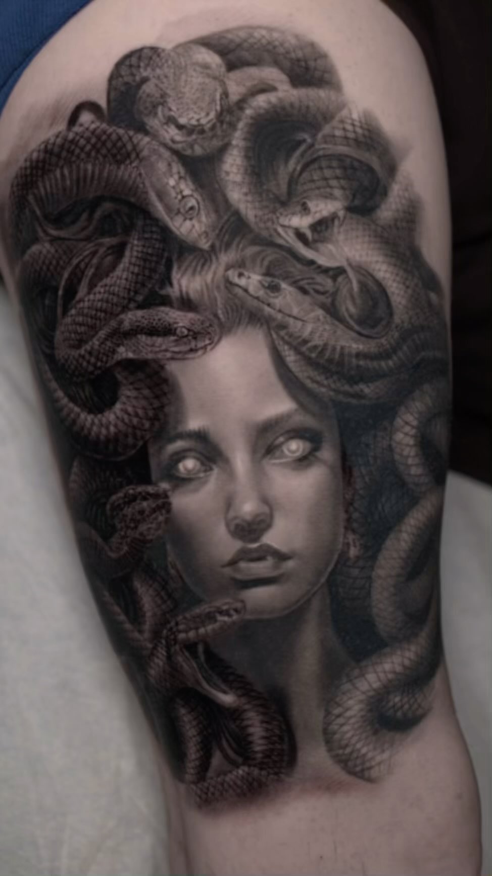 Black-and-grey Medusa portrait, thigh