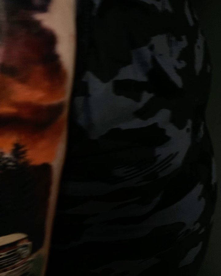 Color memorial tattoo with sunset and truck, arm