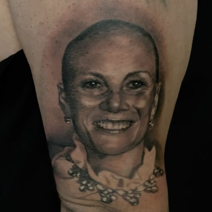 Black-and-grey memorial portrait tattoo