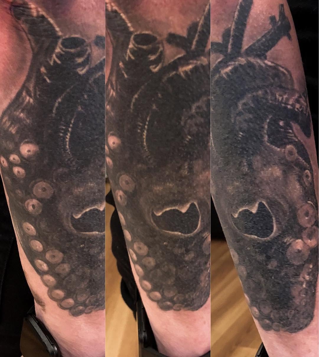 Black-and-grey octopus heart tattoo, forearm