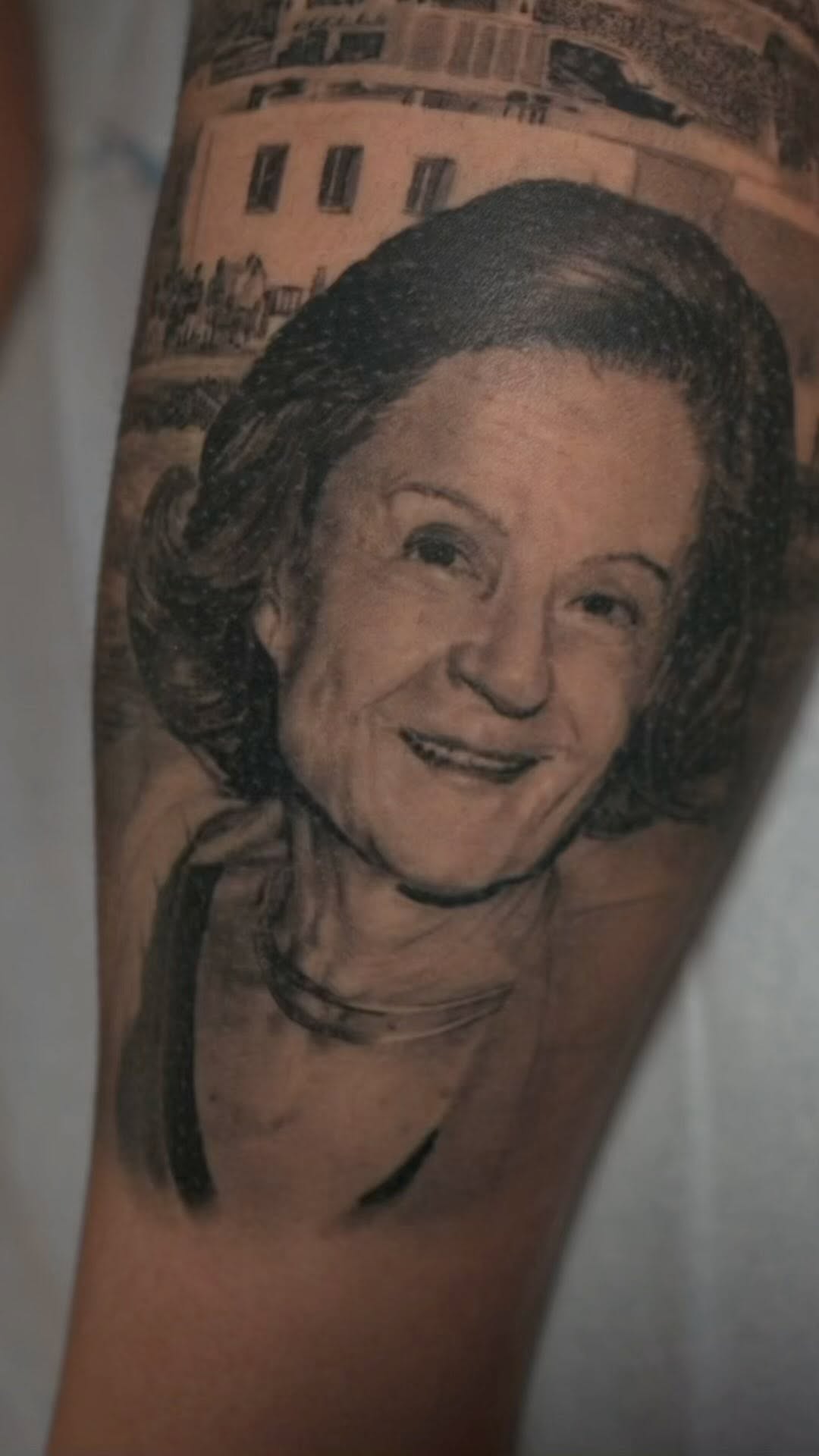 Black-and-grey portrait of mother, forearm