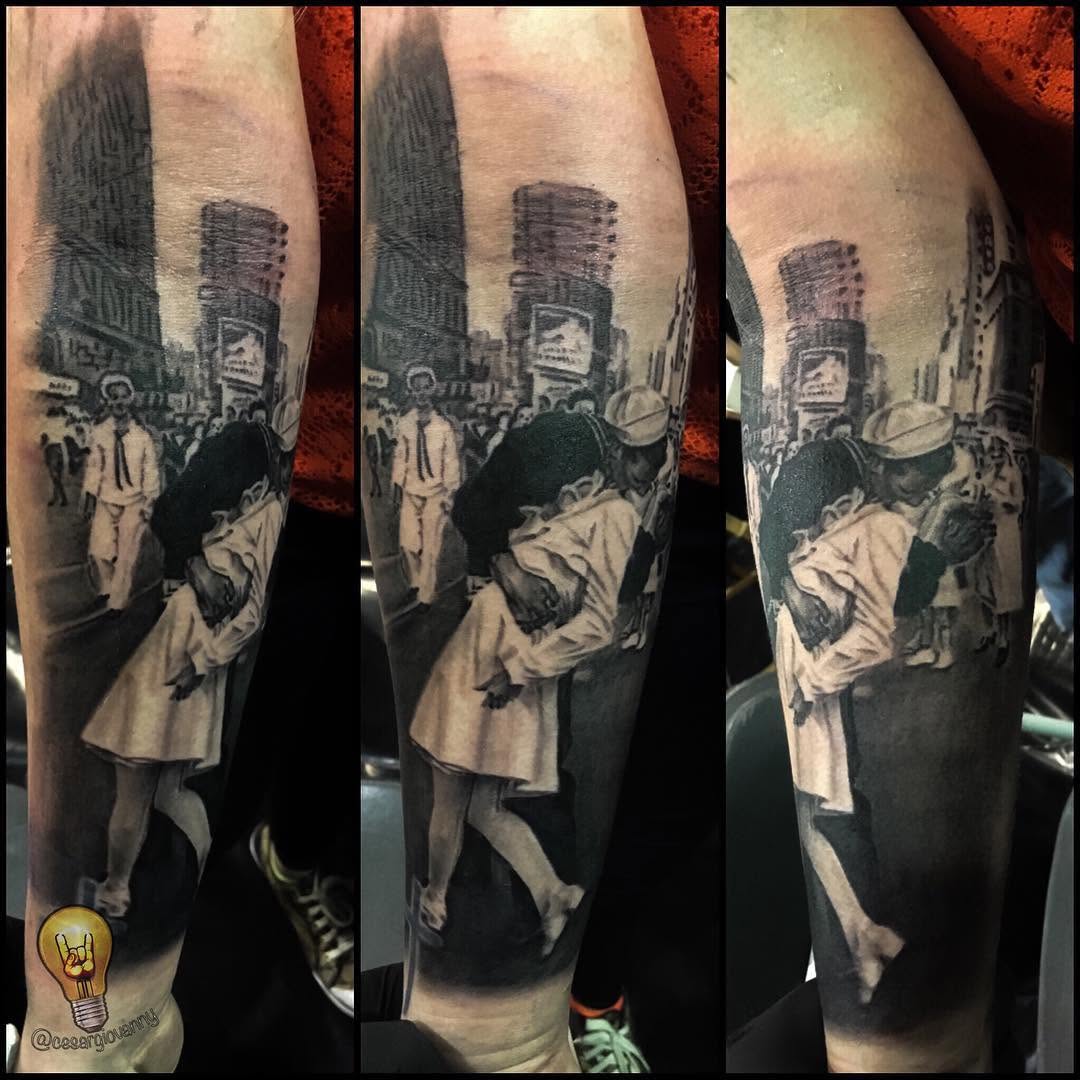 V-J Day kiss black-and-grey realism, forearm