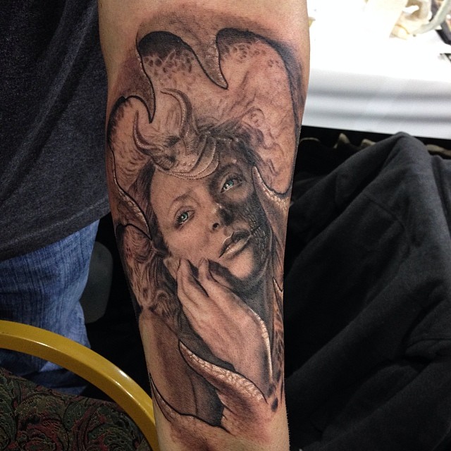 Black-and-grey horned woman portrait, forearm