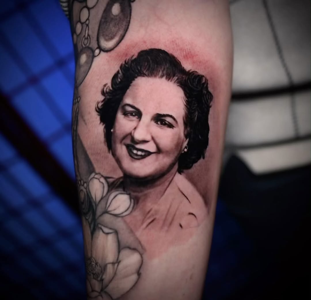 Black-and-grey grandmother portrait tattoo, forearm