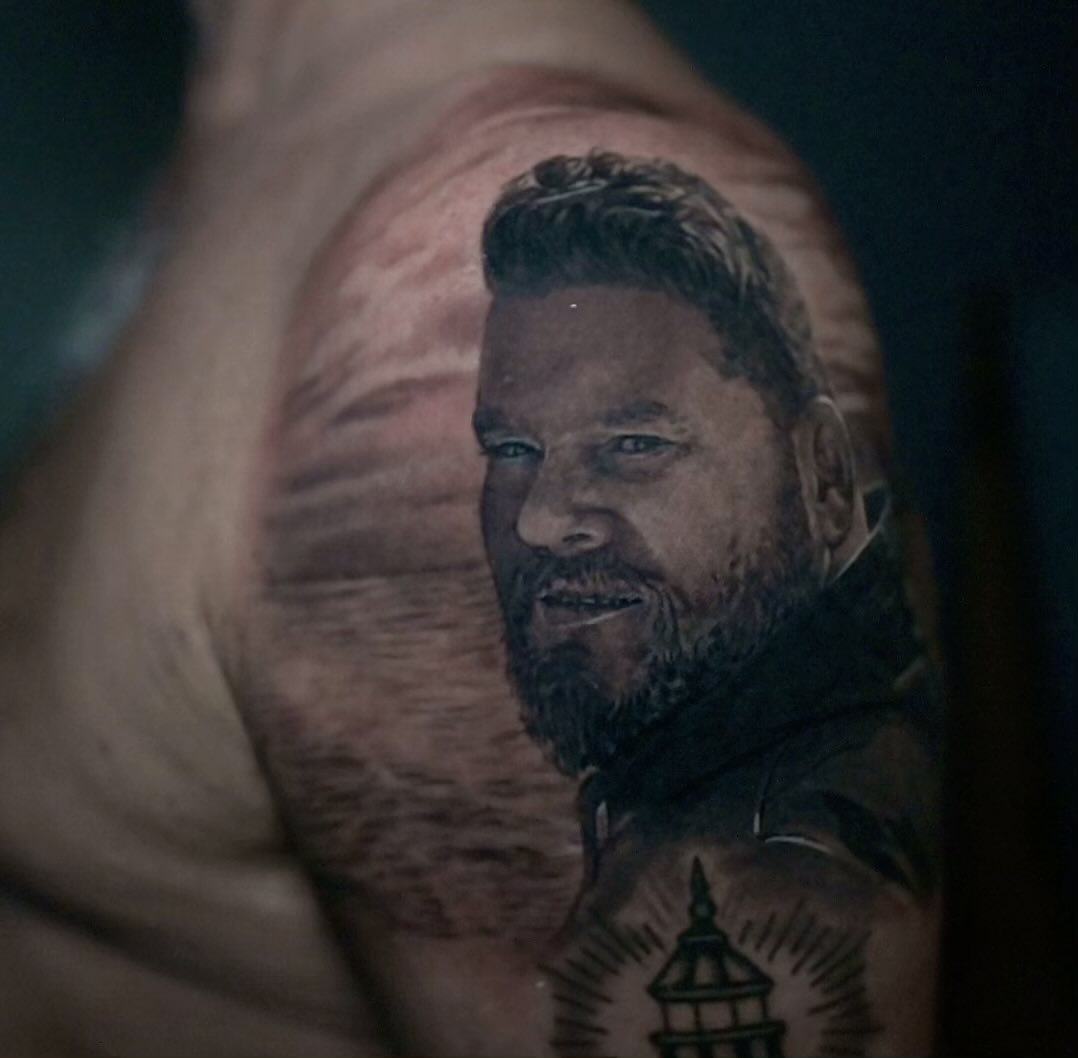 Black-and-grey memorial portrait tattoo, bicep