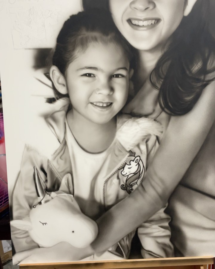 Black-and-grey airbrush portrait of artist's kids