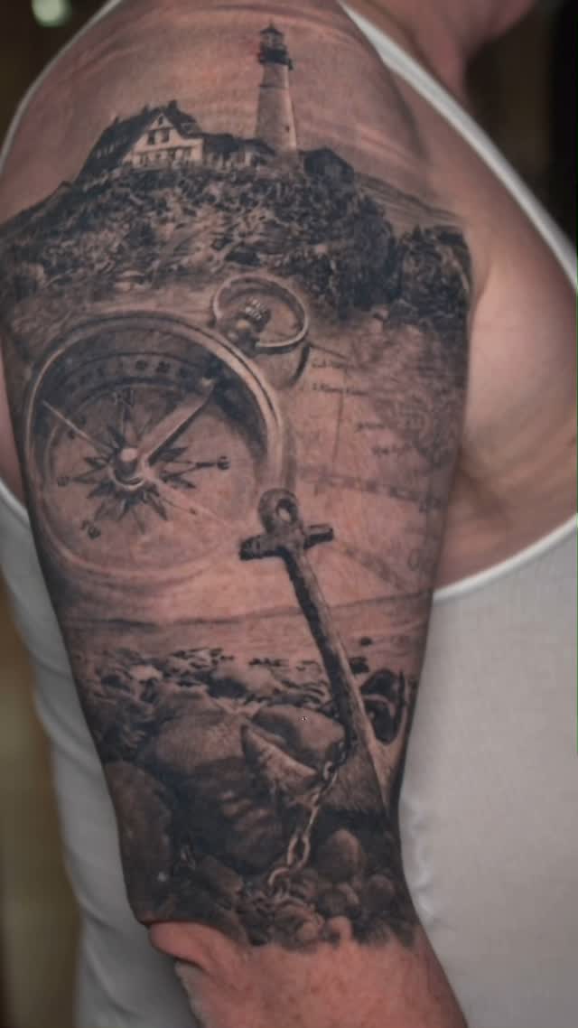 Black-and-grey nautical half-sleeve, lighthouse & anchor