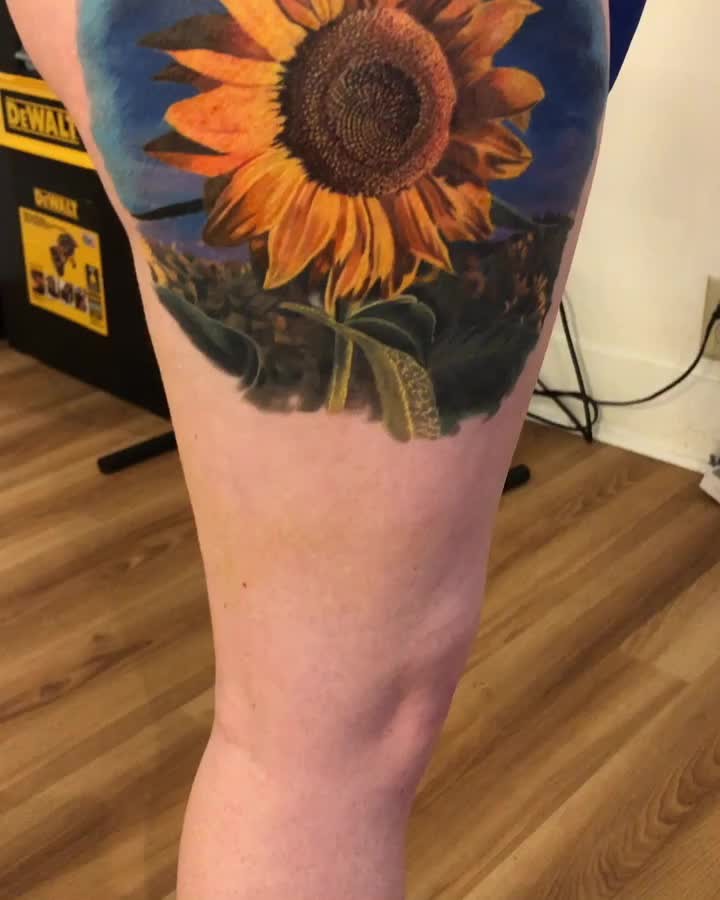 Realistic color sunflower tattoo, thigh
