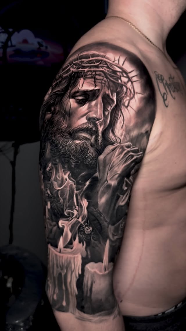 Black-and-grey Jesus half sleeve with candles