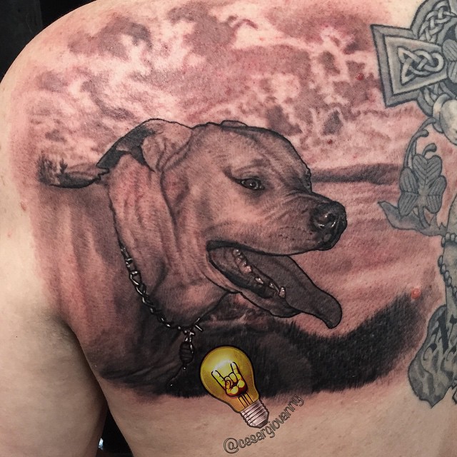 Black-and-grey dog portrait tattoo on back