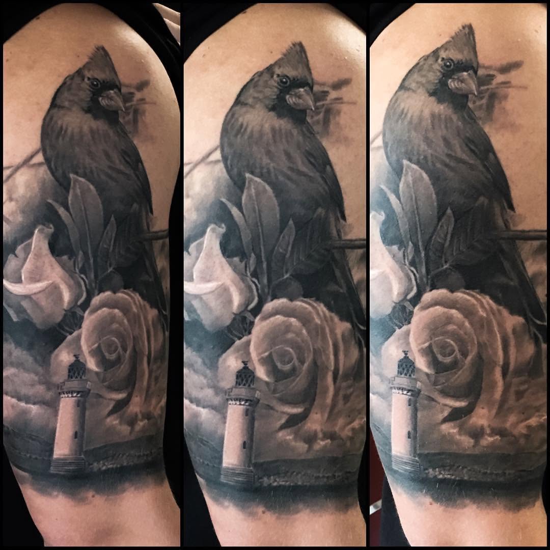 Black-and-grey cardinal, rose & lighthouse half-sleeve