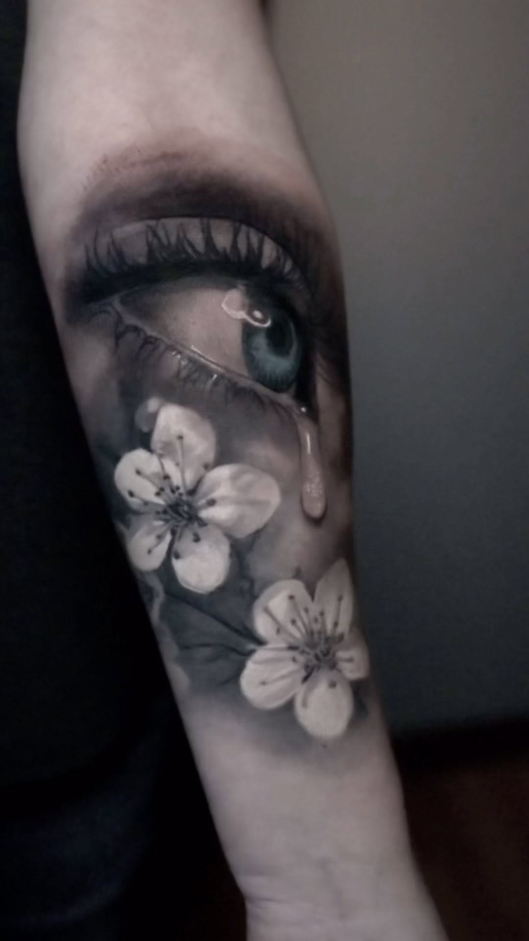 Realistic crying eye and cherry blossoms, forearm