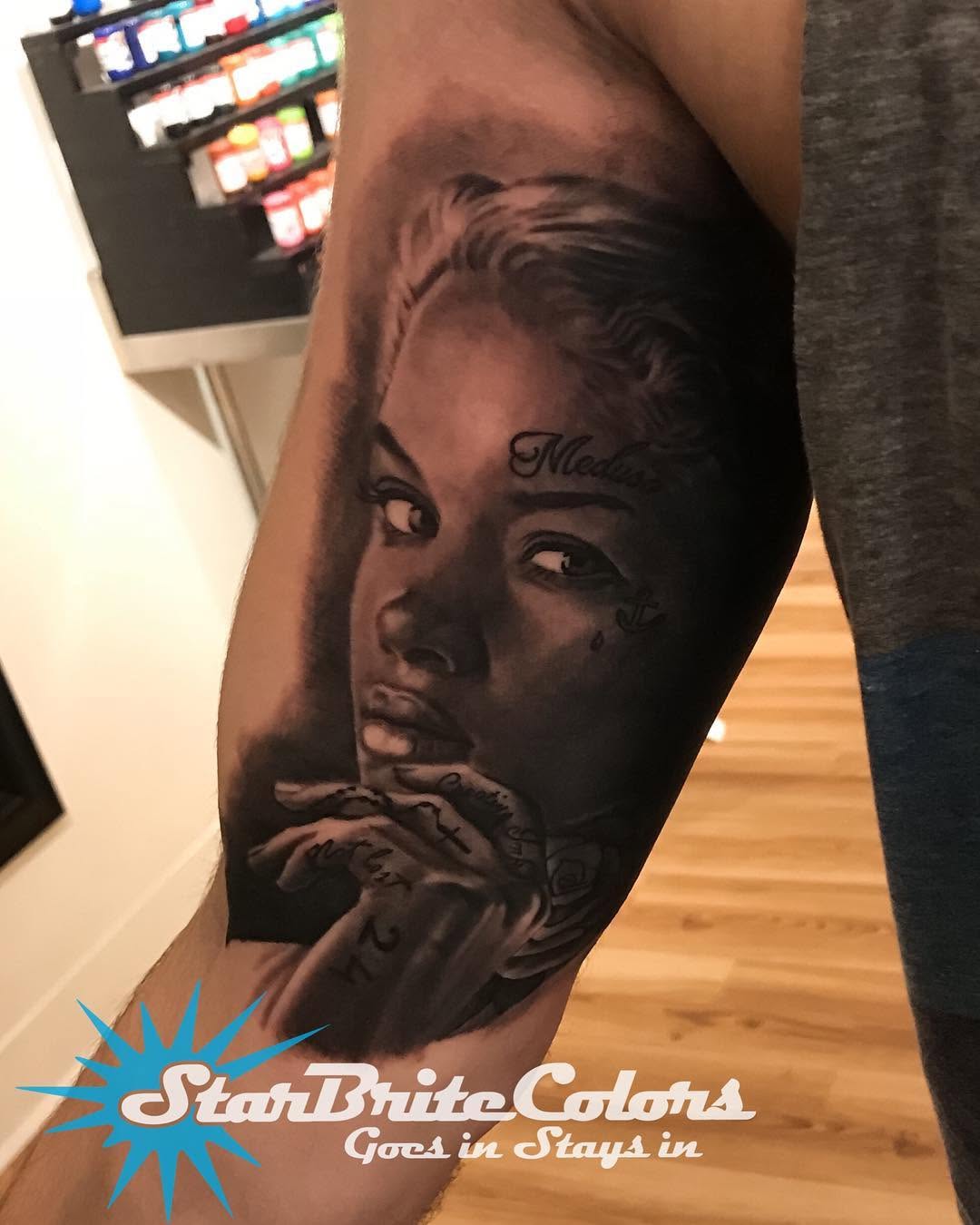 Black-and-grey Medusa portrait, bicep
