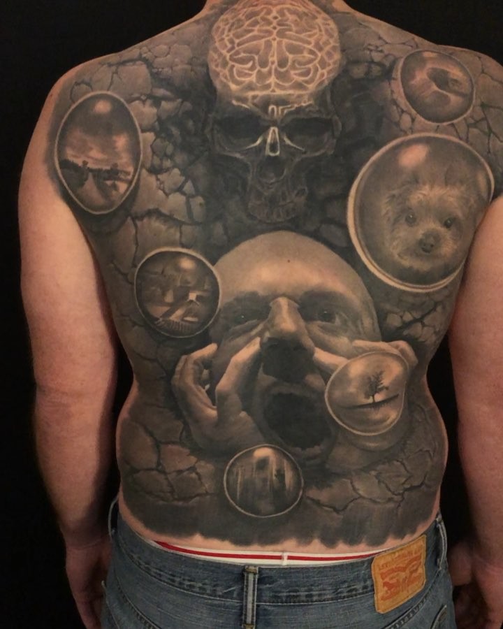 Surreal skull back piece in black-and-grey