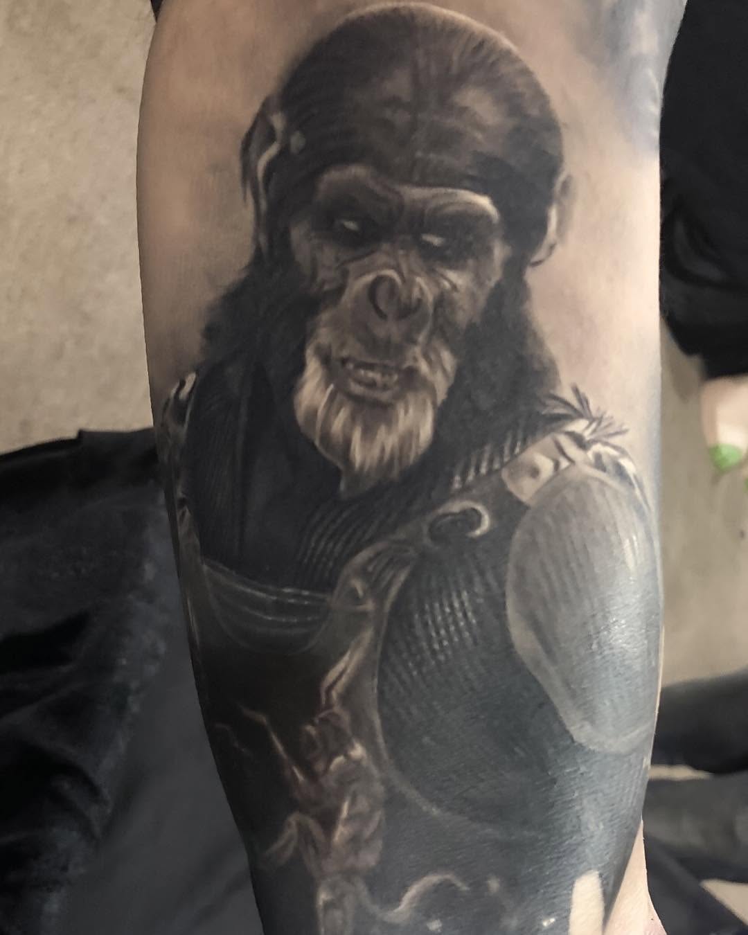 Black-and-grey Thade portrait tattoo, arm