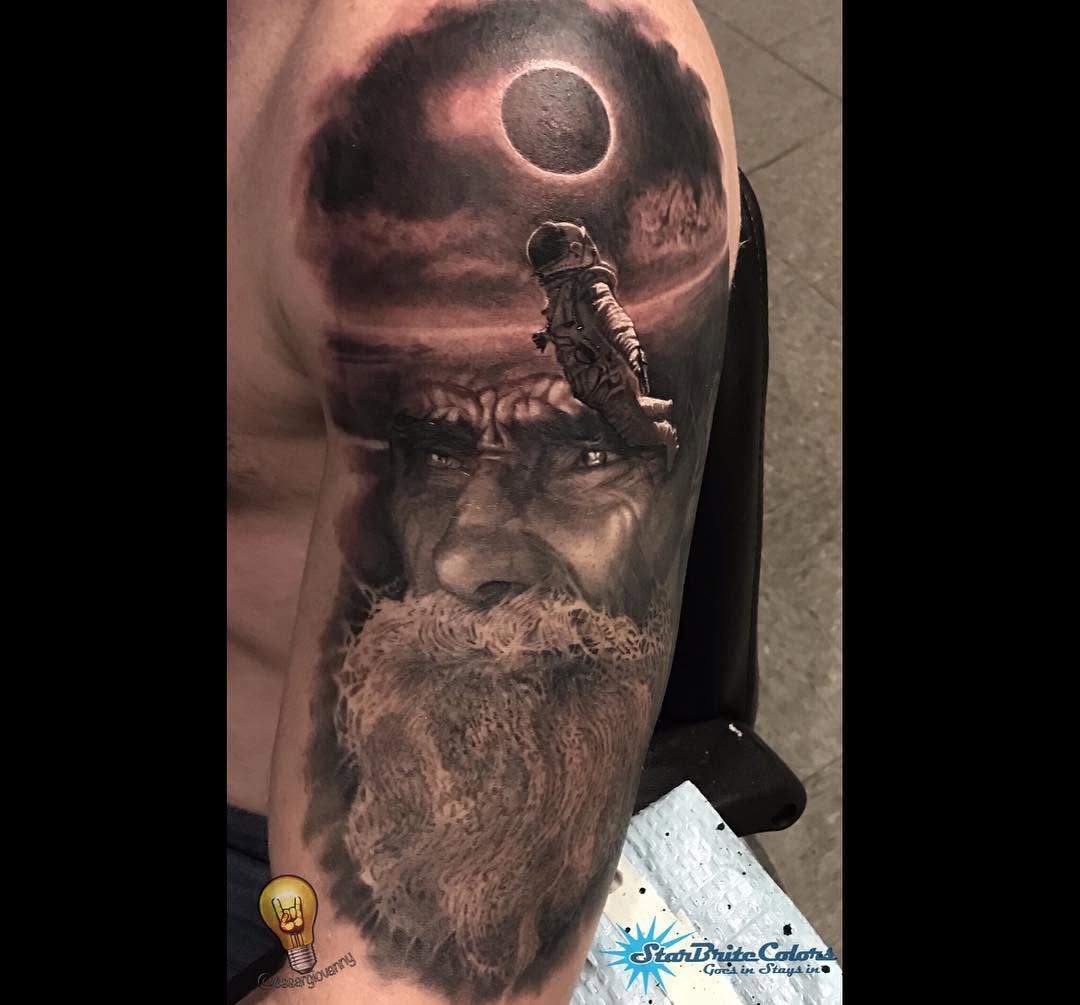 Black-and-grey bearded man portrait with astronaut, arm