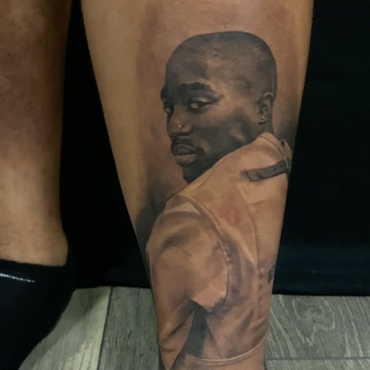 Tupac portrait tattoo, black-and-grey calf