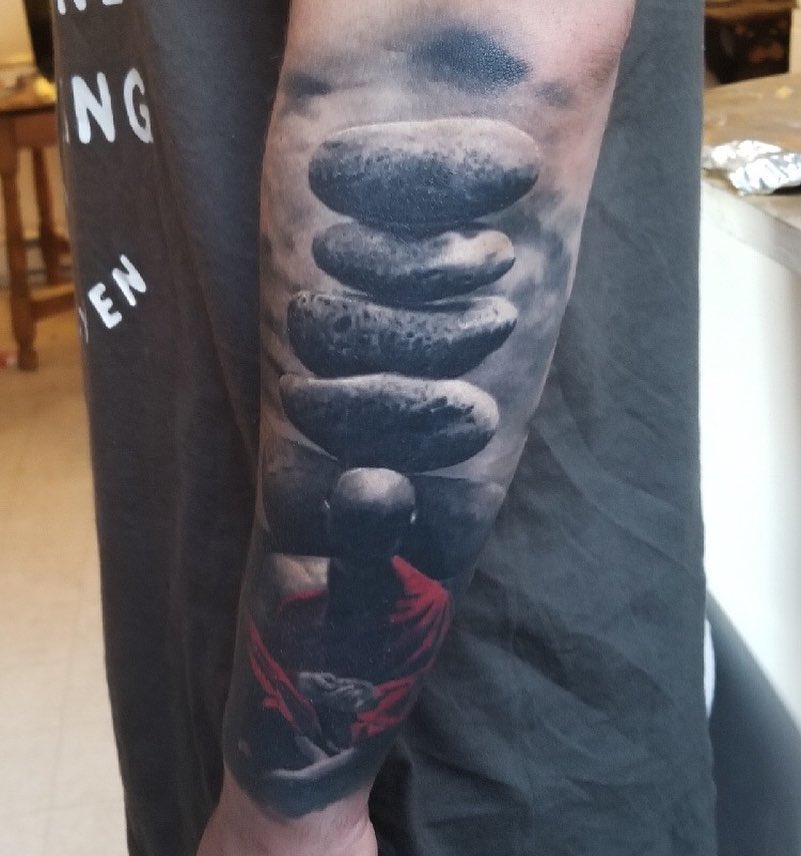 Buddha and stone cairn realism tattoo, forearm