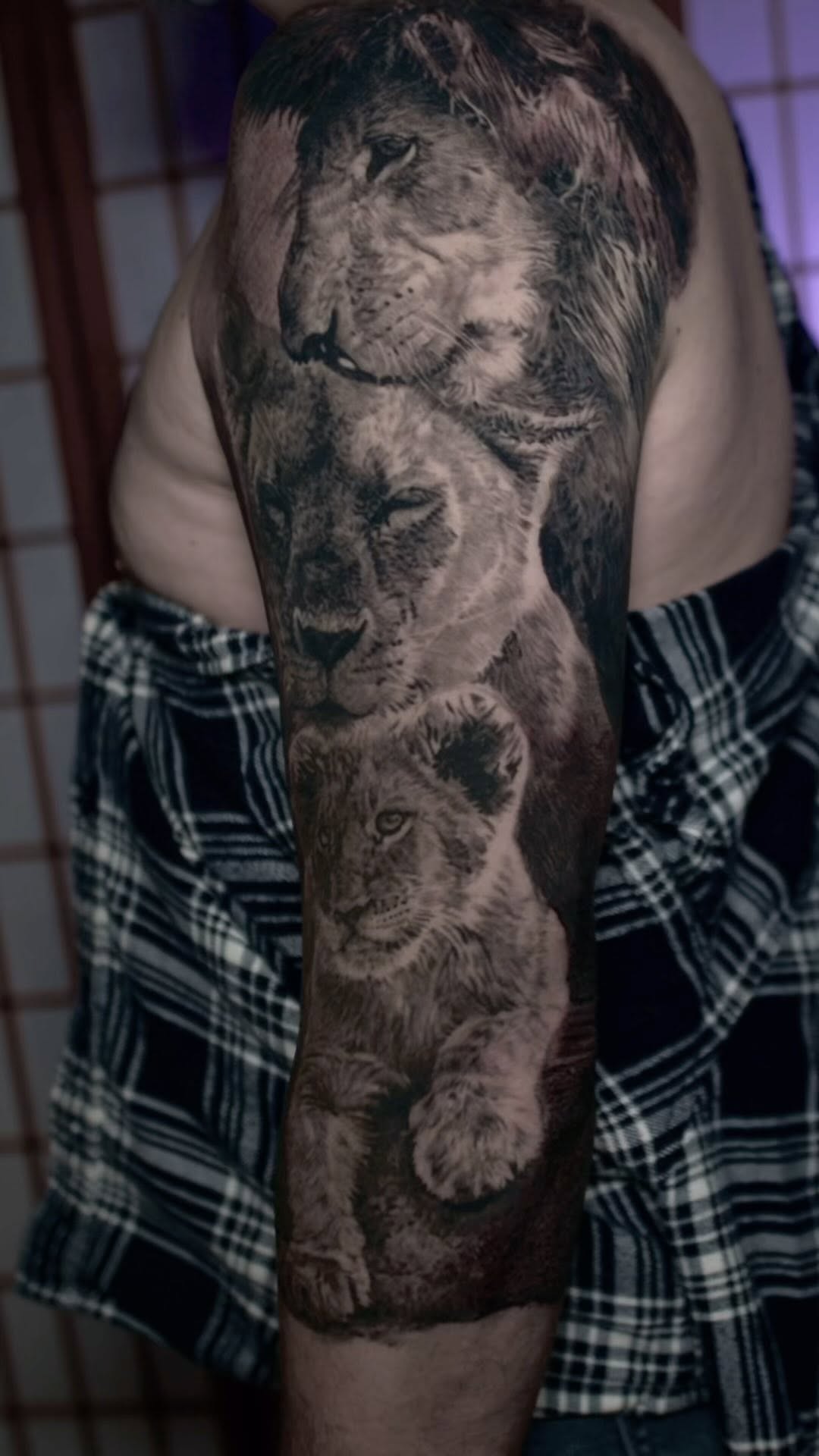 Black-and-grey lion family half-sleeve