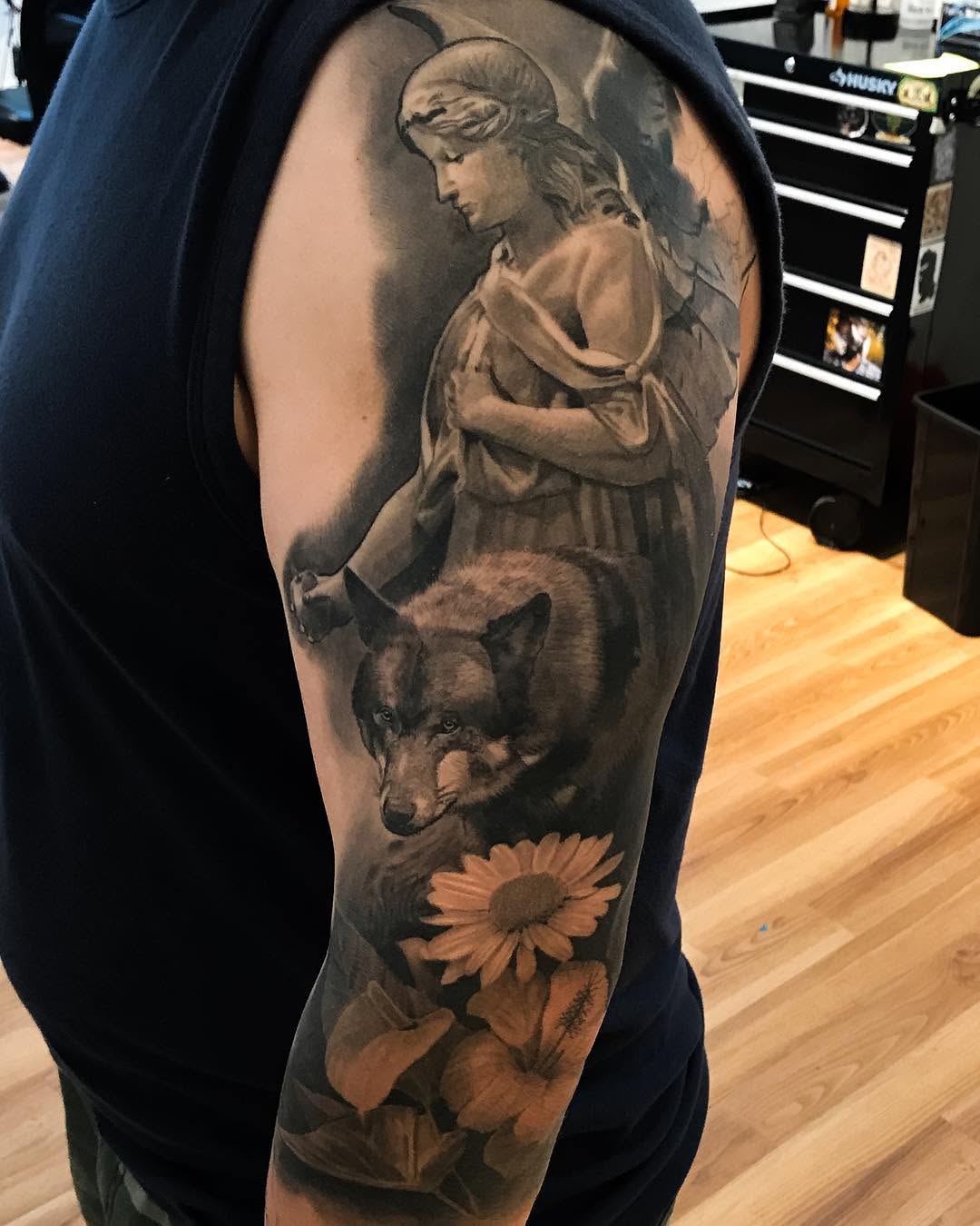 Black-and-grey angel, wolf & flowers half-sleeve