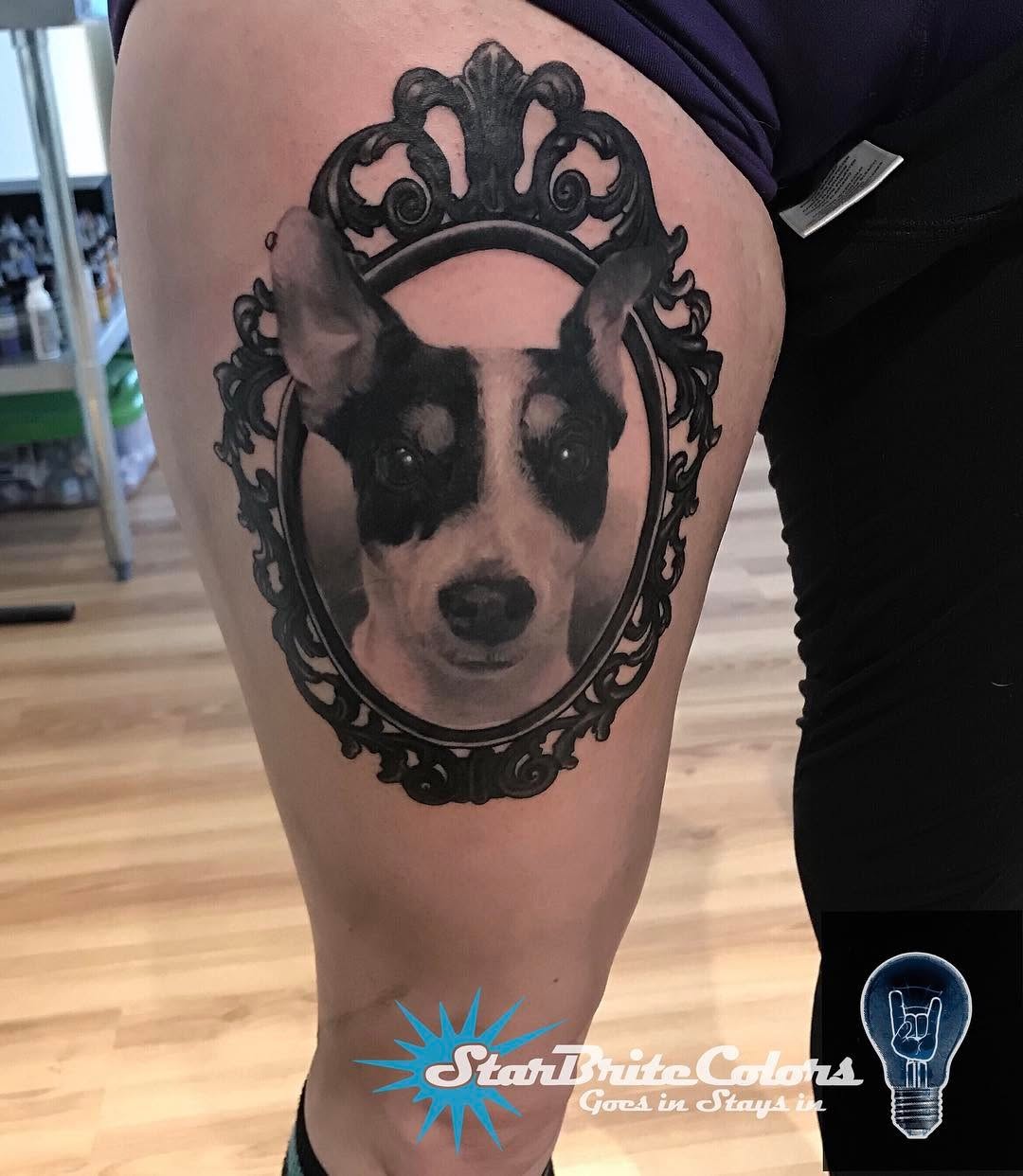 Black-and-grey dog portrait in ornate frame, thigh