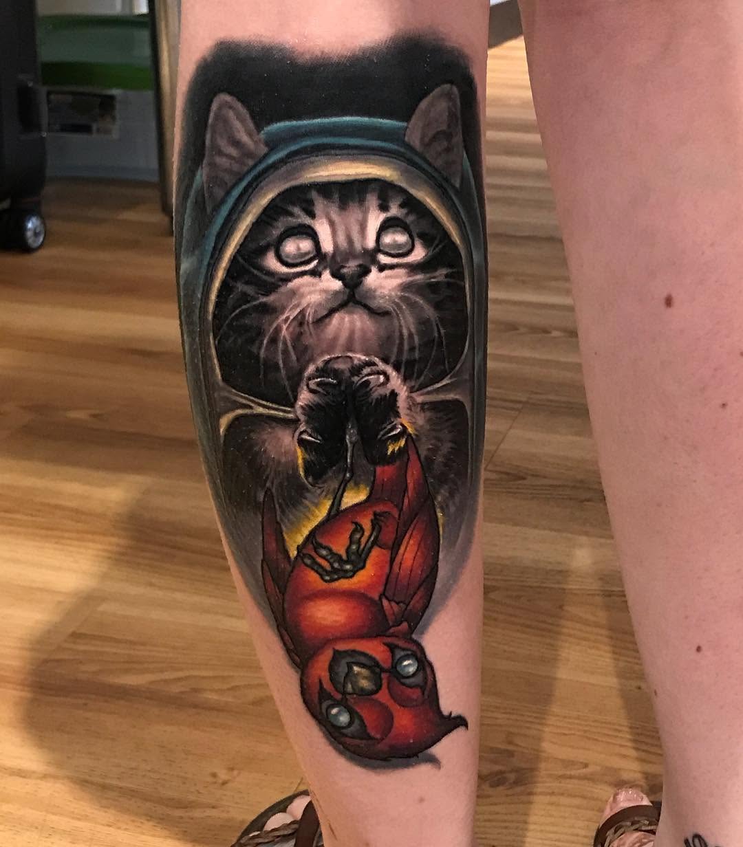 Hooded kitten and Deadpool collab tattoo, calf