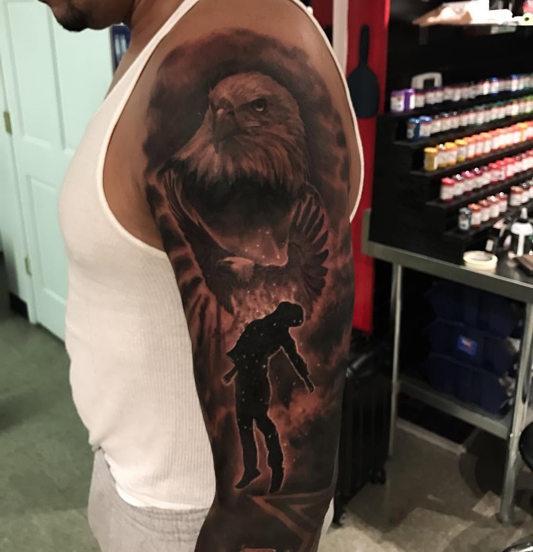 Black-and-grey eagle and soldier half-sleeve