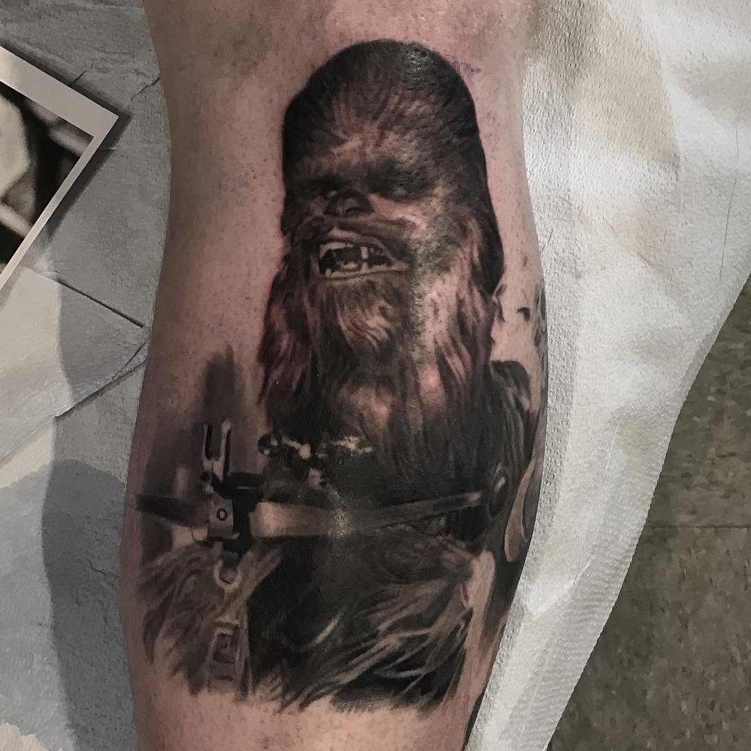 Black-and-grey Chewbacca portrait tattoo on calf