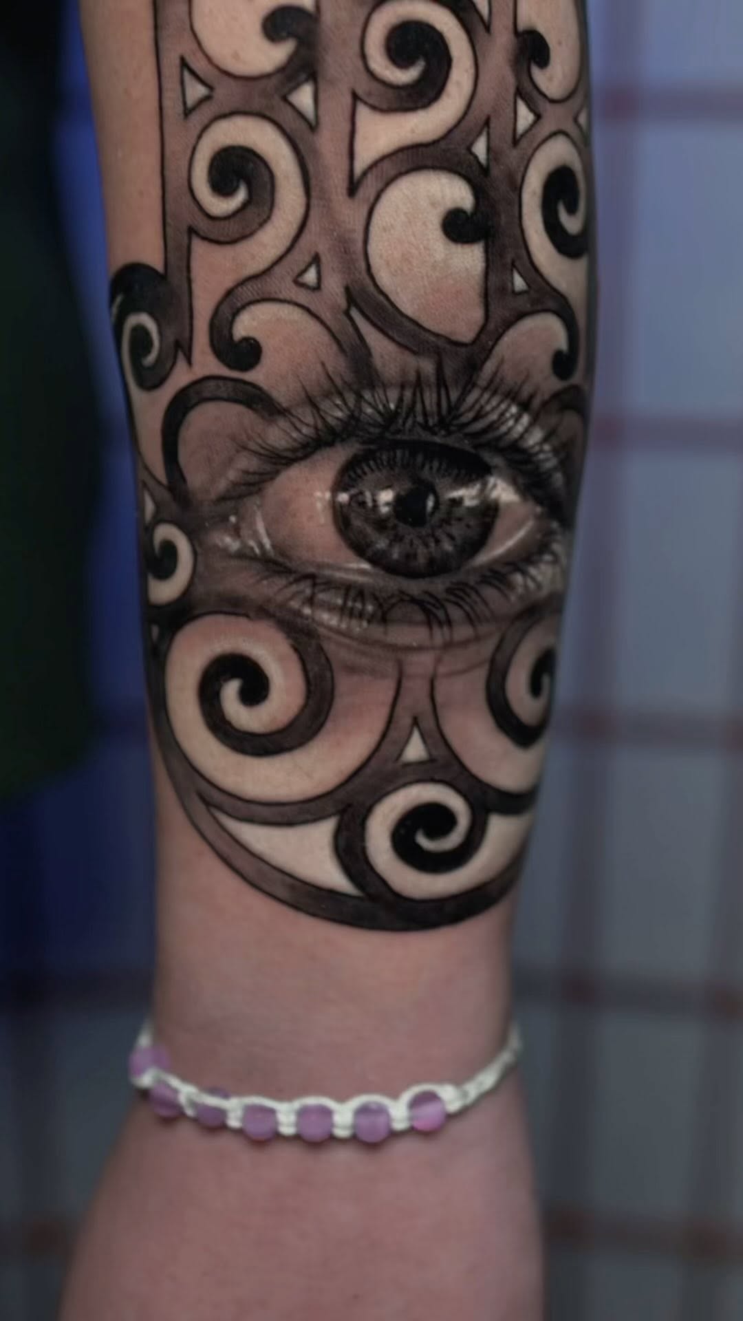 Realistic eye and Hamsa hand tattoo, forearm