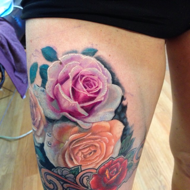 Realistic color rose tattoo on thigh