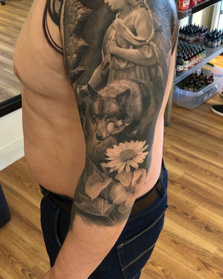 Black-and-grey wolf and floral half-sleeve
