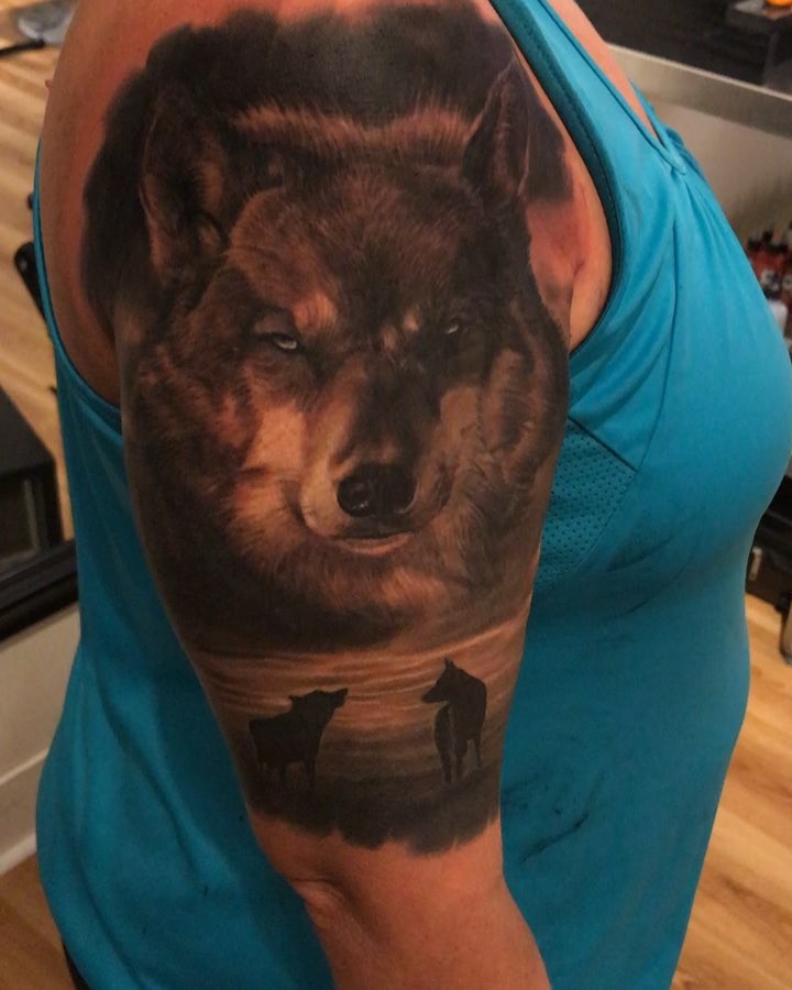 Black-and-grey wolf portrait half-sleeve