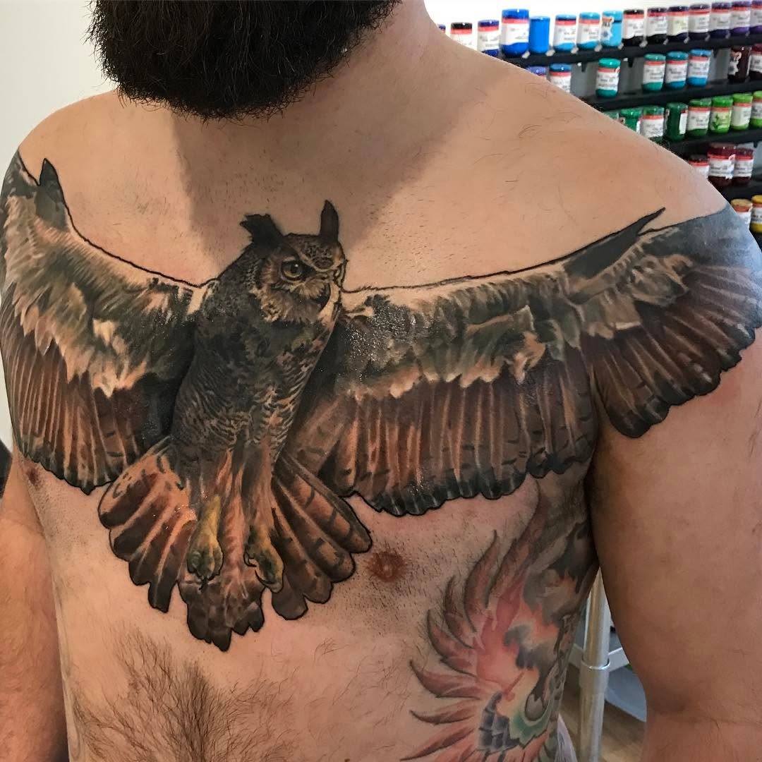 Realistic owl chest tattoo with spread wings
