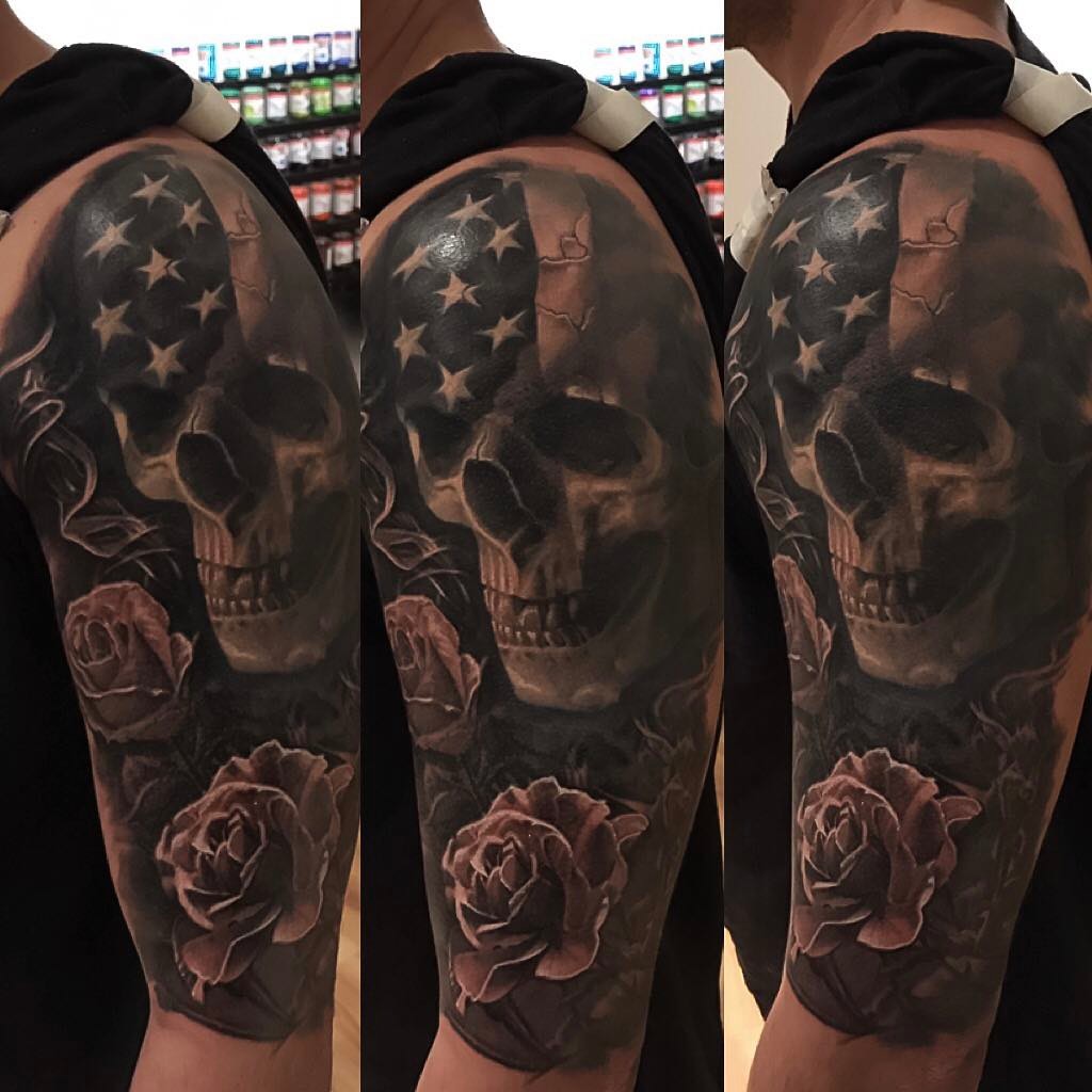 Black-and-grey skull, flag & roses half-sleeve