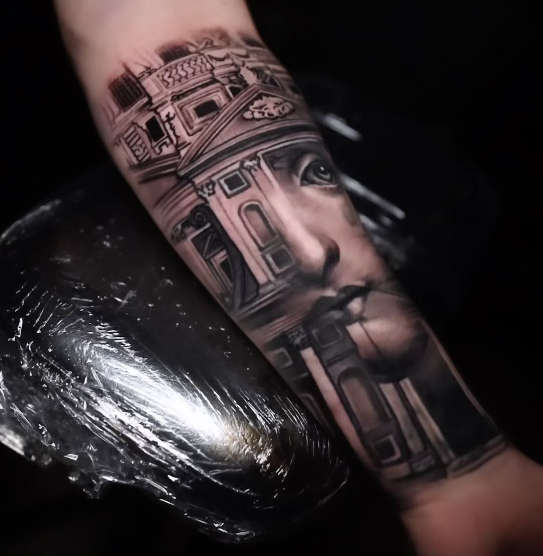 Black-and-grey Fornasetti-inspired forearm tattoo