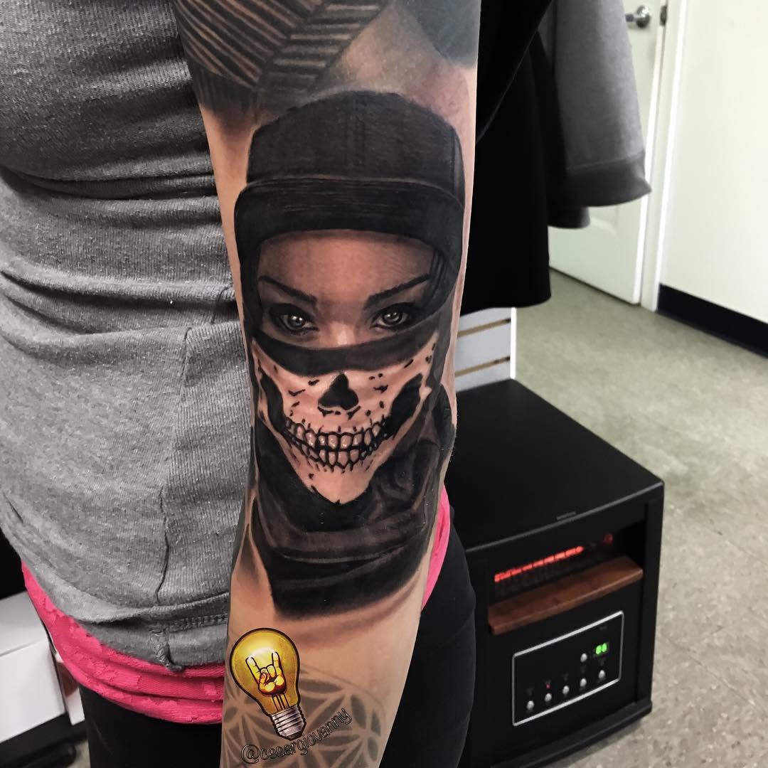 Black-and-grey skull-masked woman portrait, arm