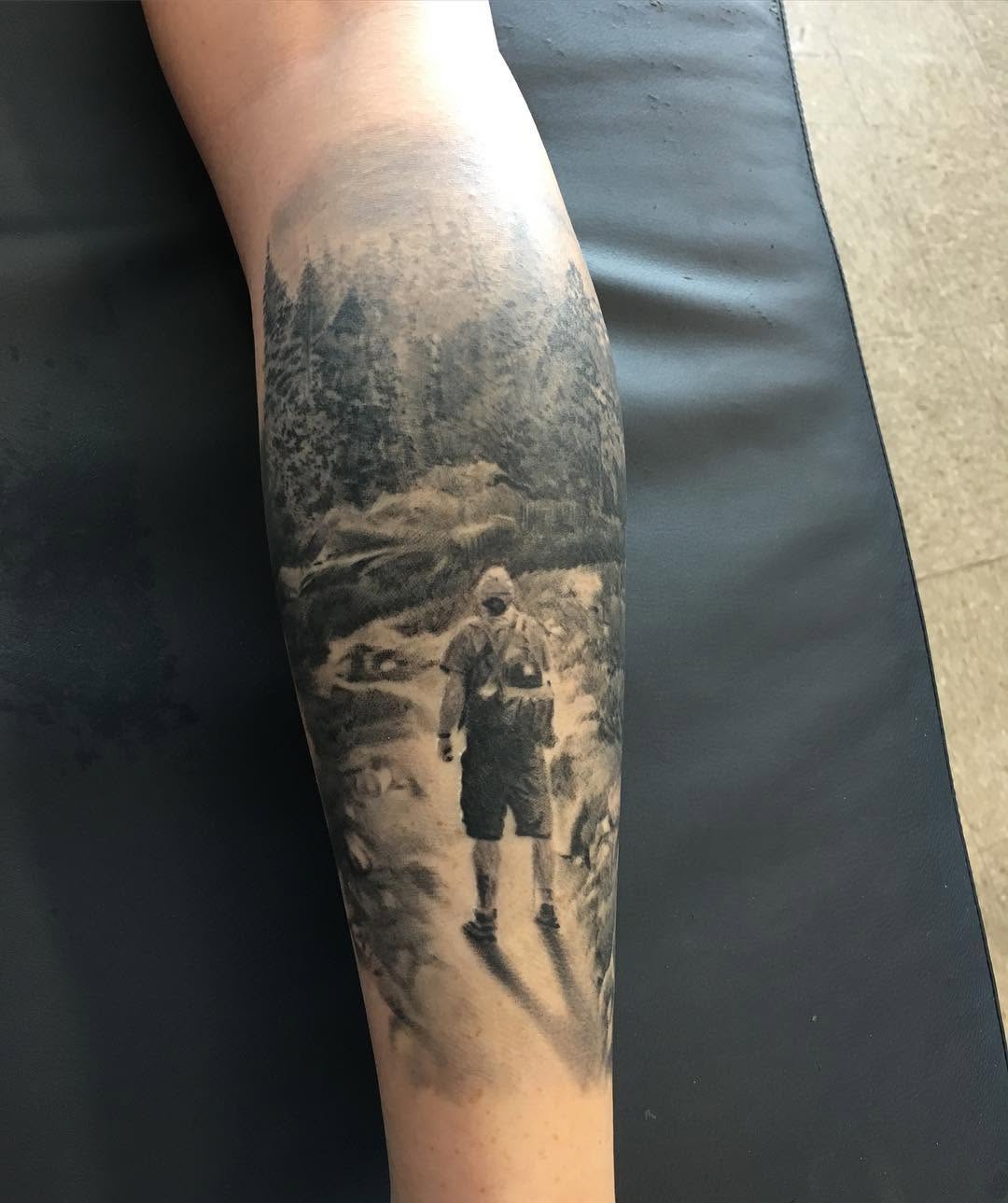 Black-and-grey hiker in forest scene, forearm
