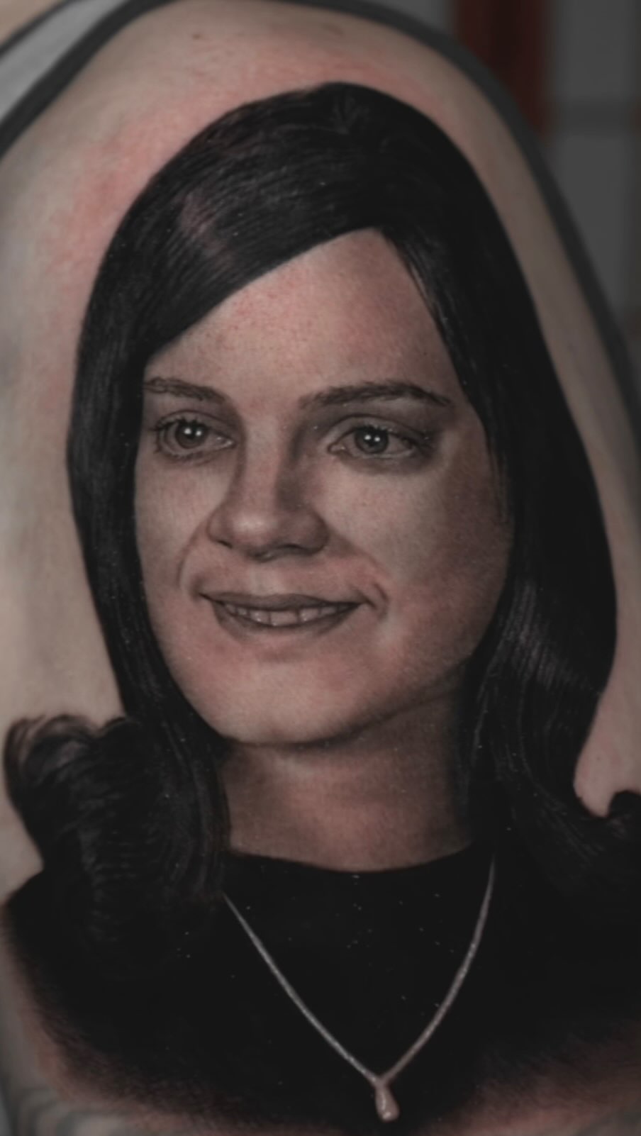 Black-and-grey portrait tattoo of mother