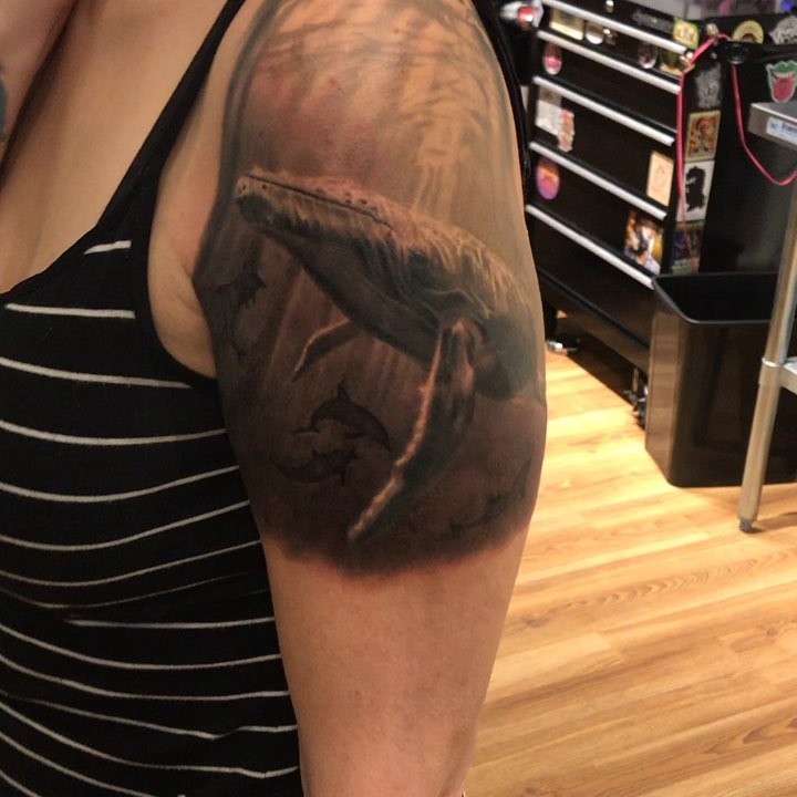 Black-and-grey humpback whale tattoo, bicep