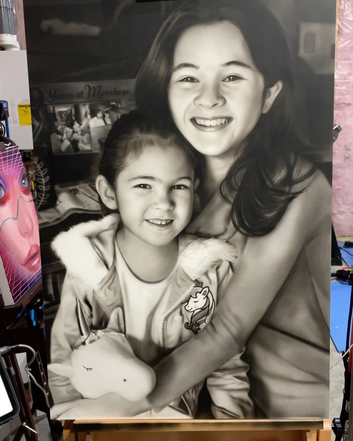 Black-and-grey airbrush portrait of artist's children